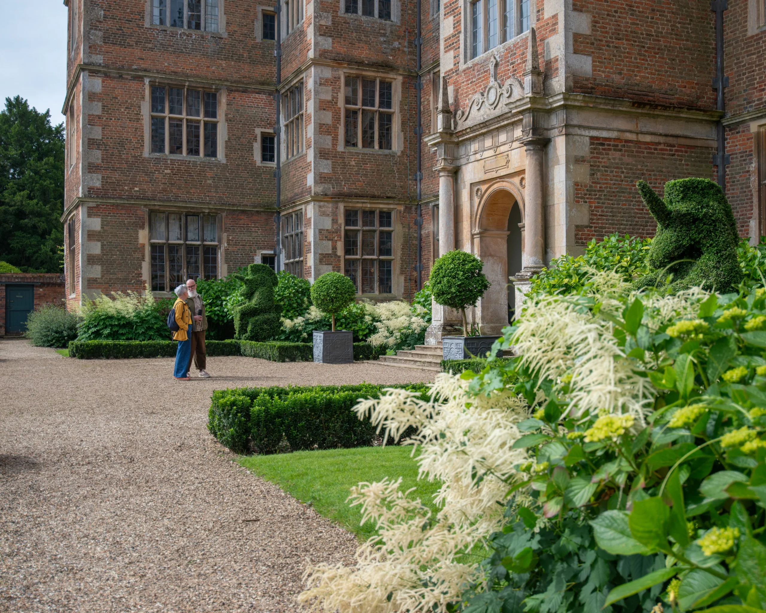 two people stood at the east front entrance of doddington hall