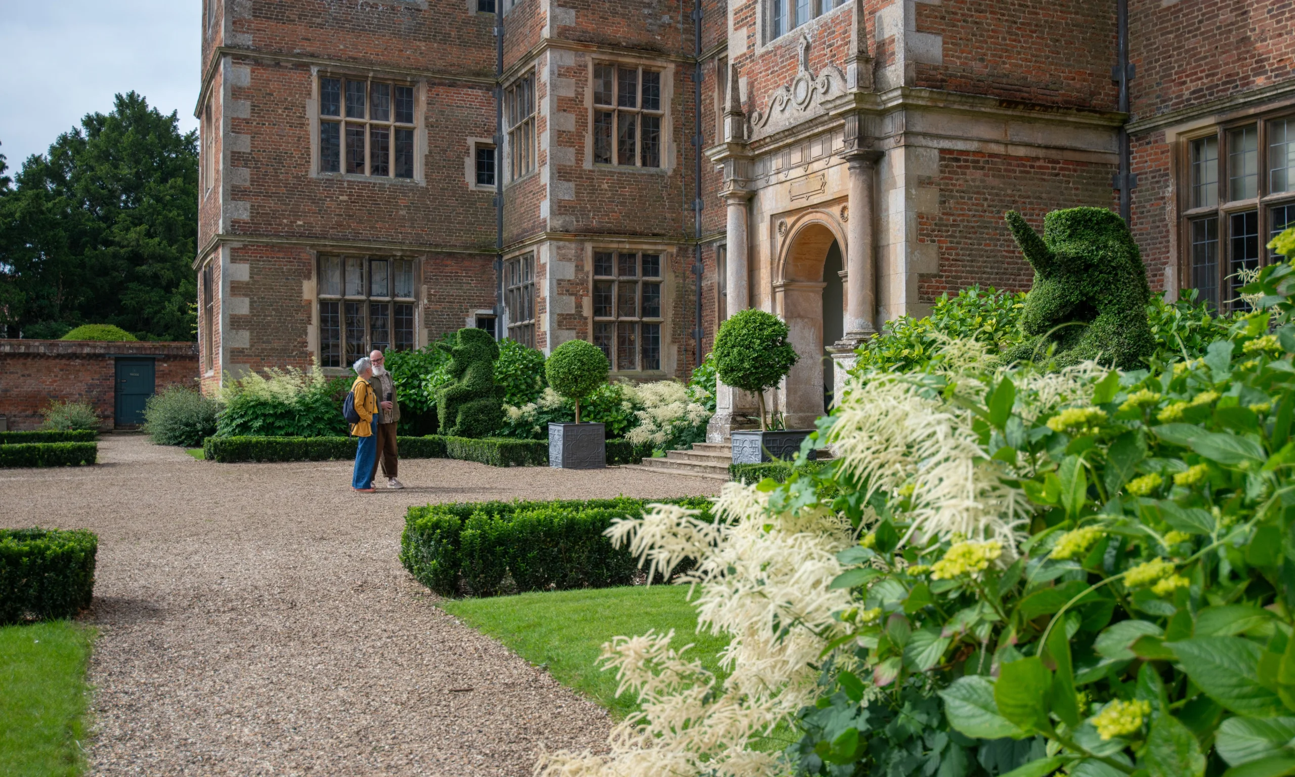two people stood at the east front entrance of doddington hall