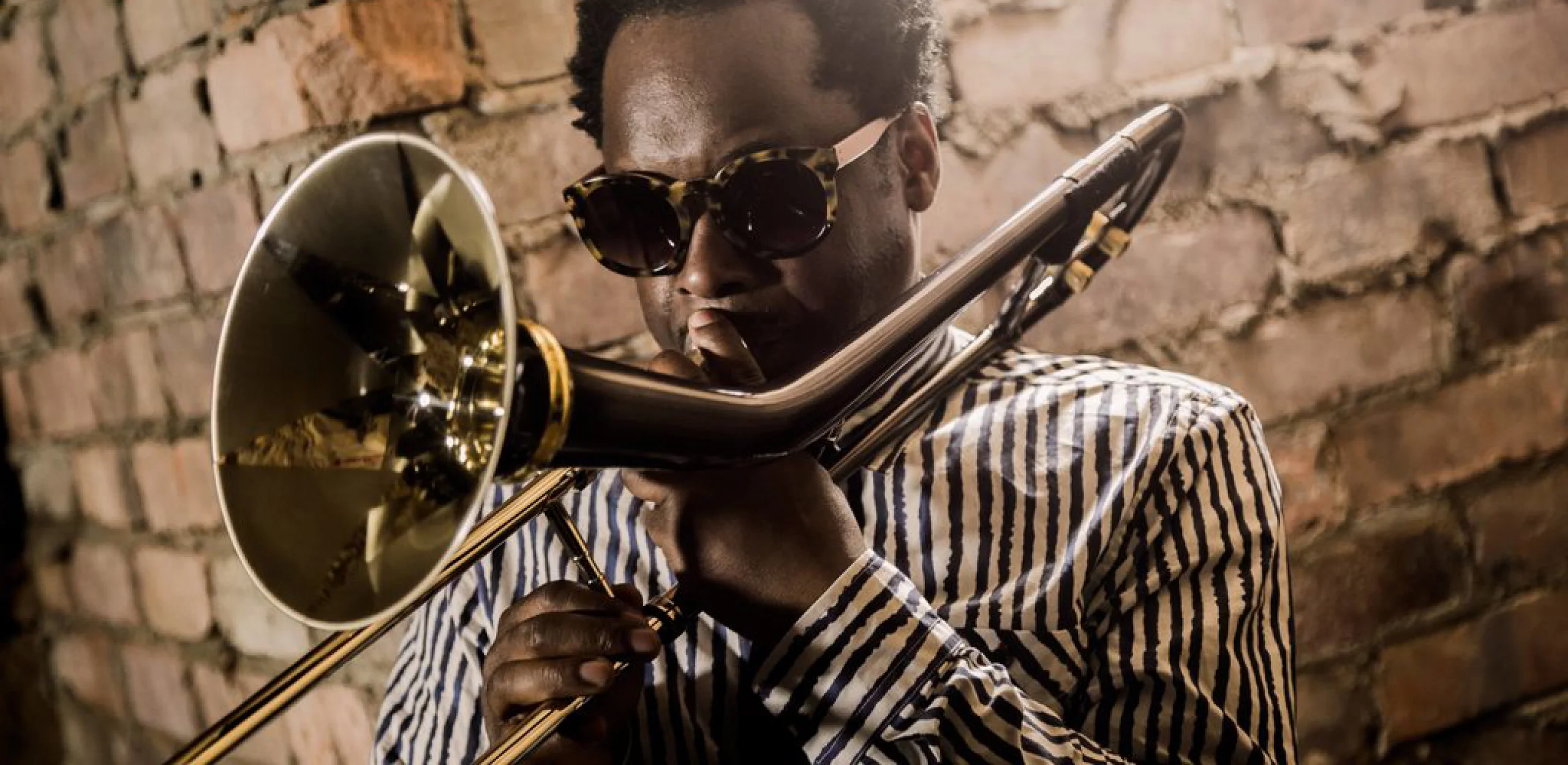 close up photo of dennis rollins playing the trombone at doddington jazz night