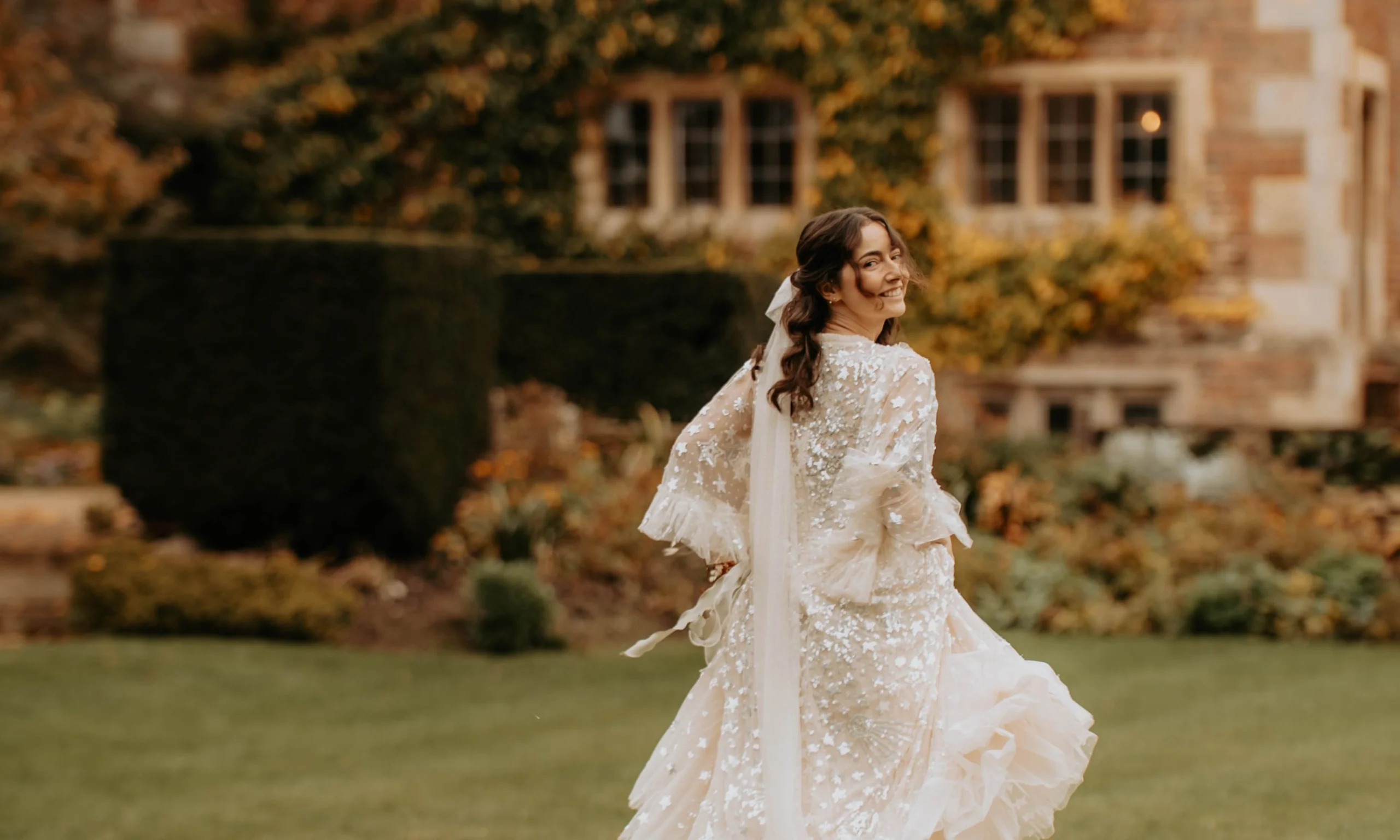 a bride walking on the grass at doddington hall