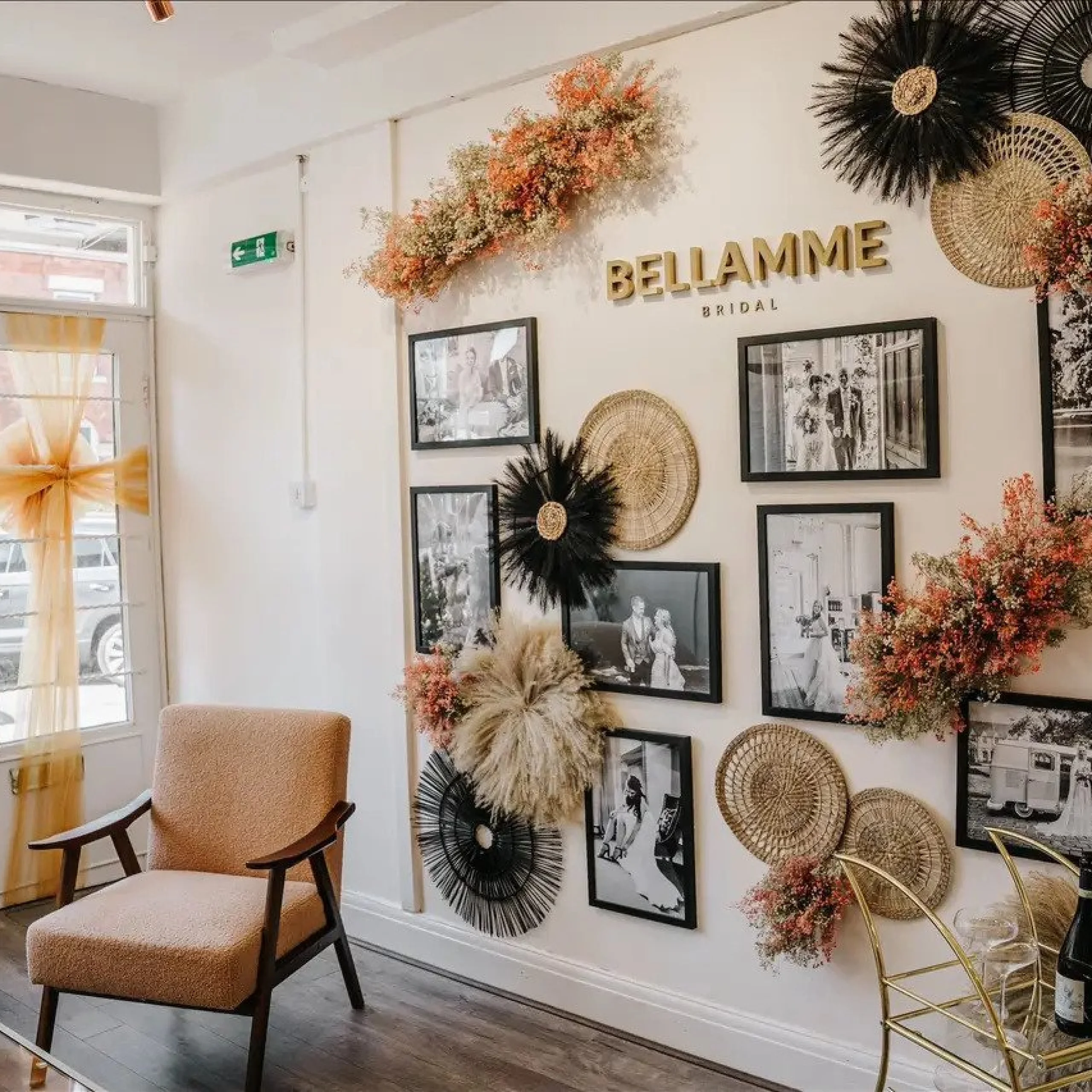 a collage of black and white photos on the wall of a bridal dress boutique