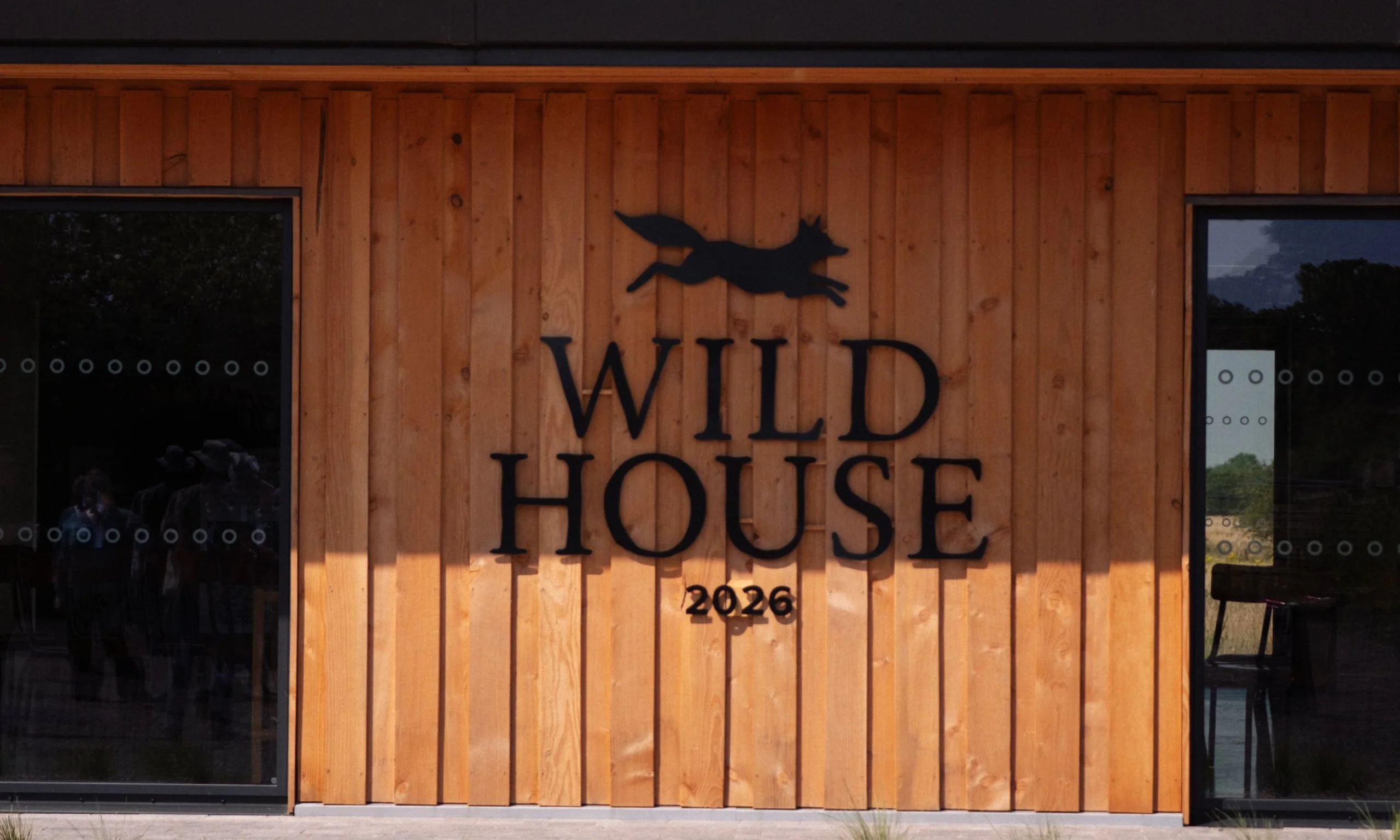 the wild house metal exterior signage