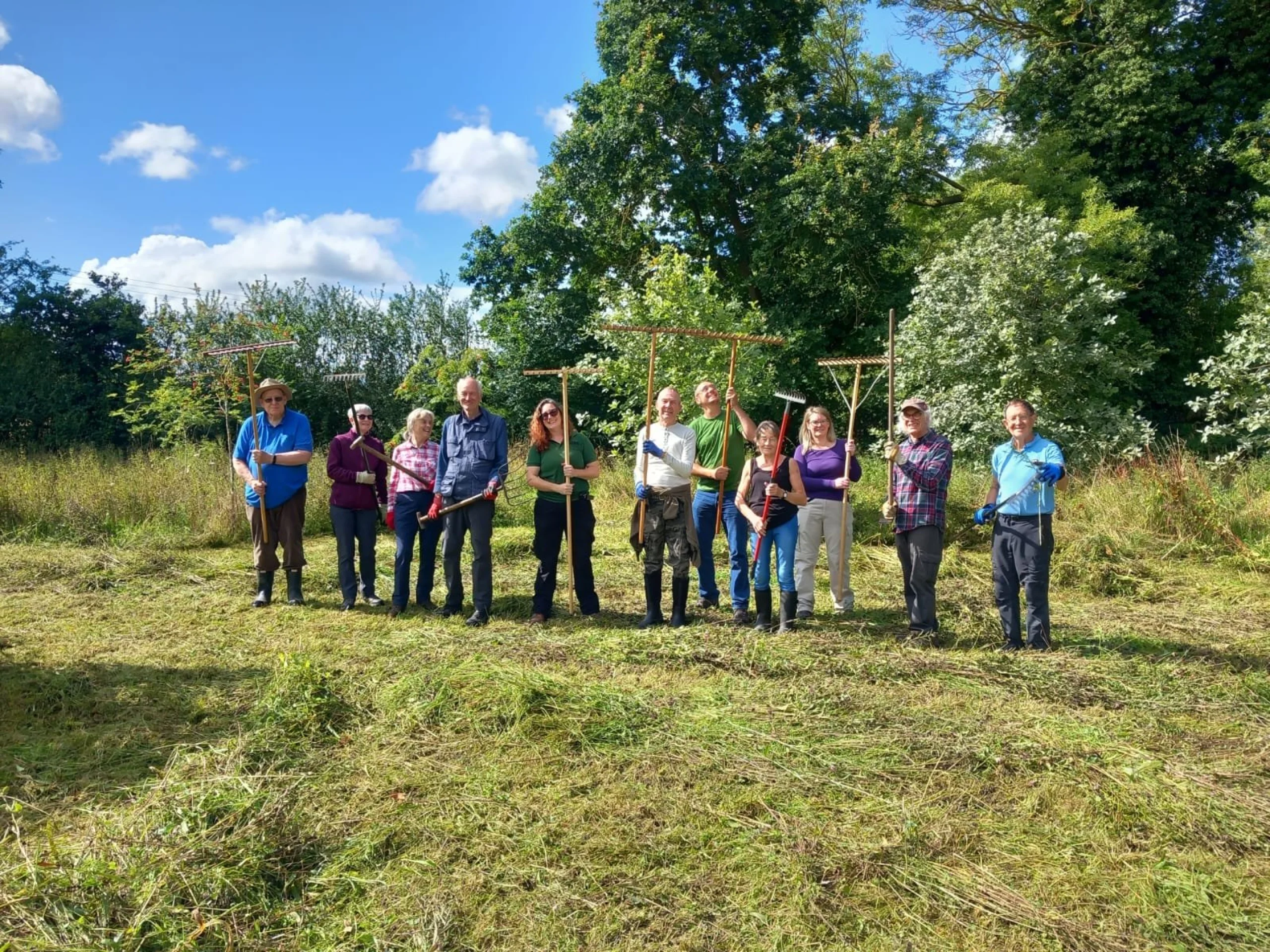 a wilder doddington volunteers with grass rakes