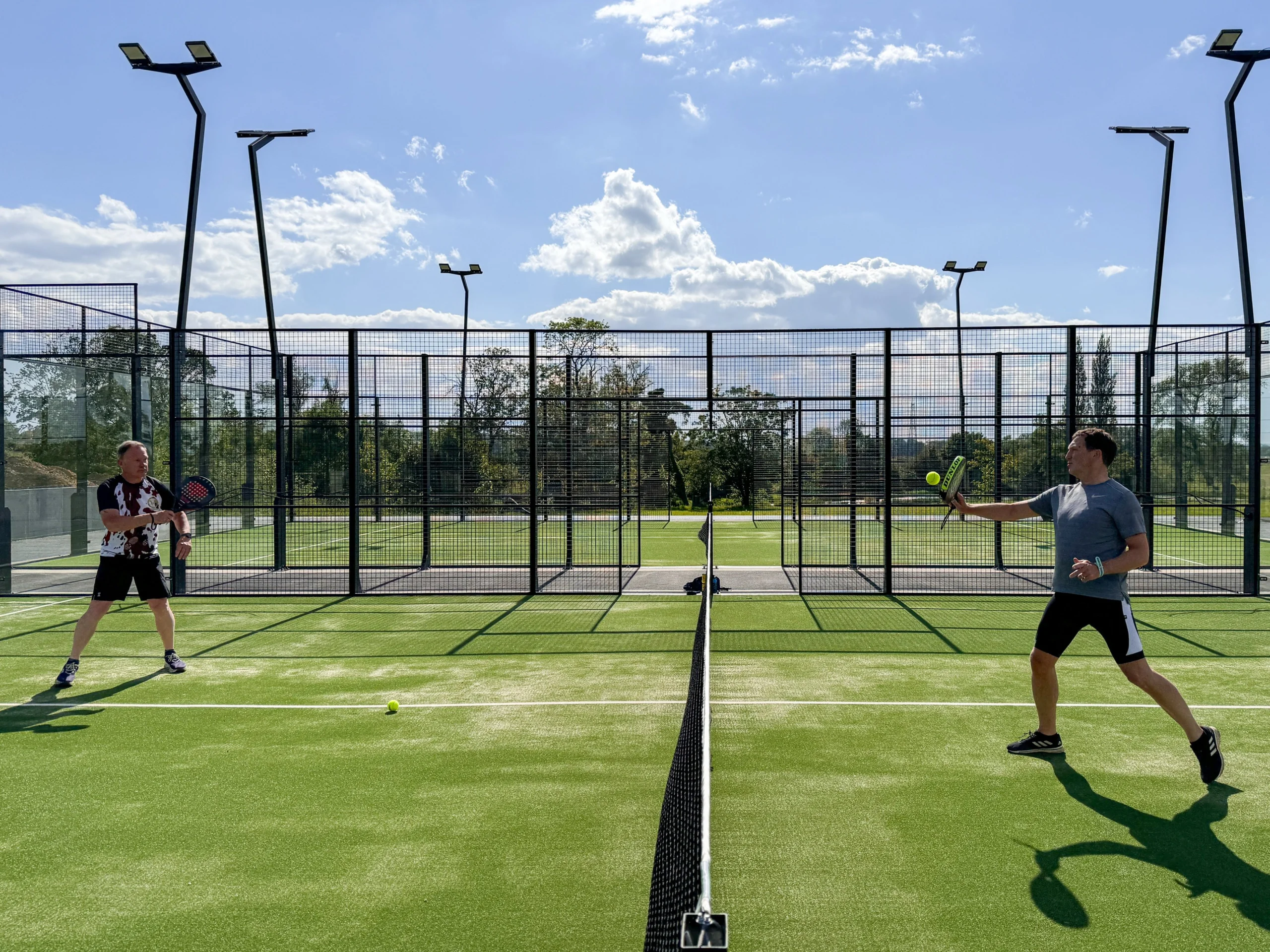 two men playing a game of padel at doddington hall