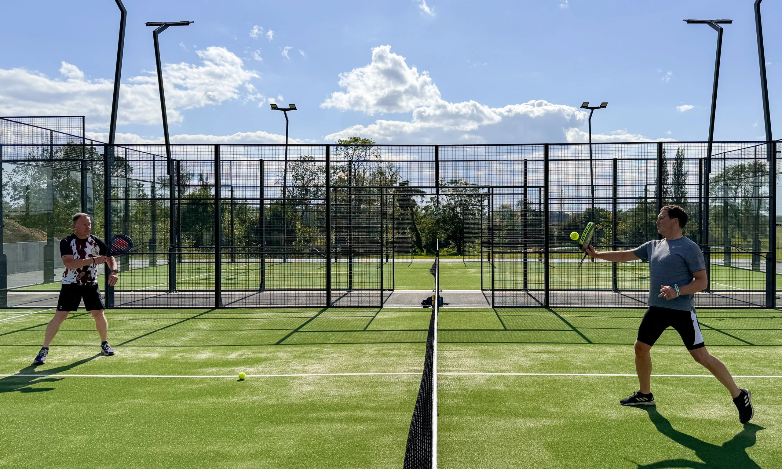 two men playing a game of padel at doddington hall