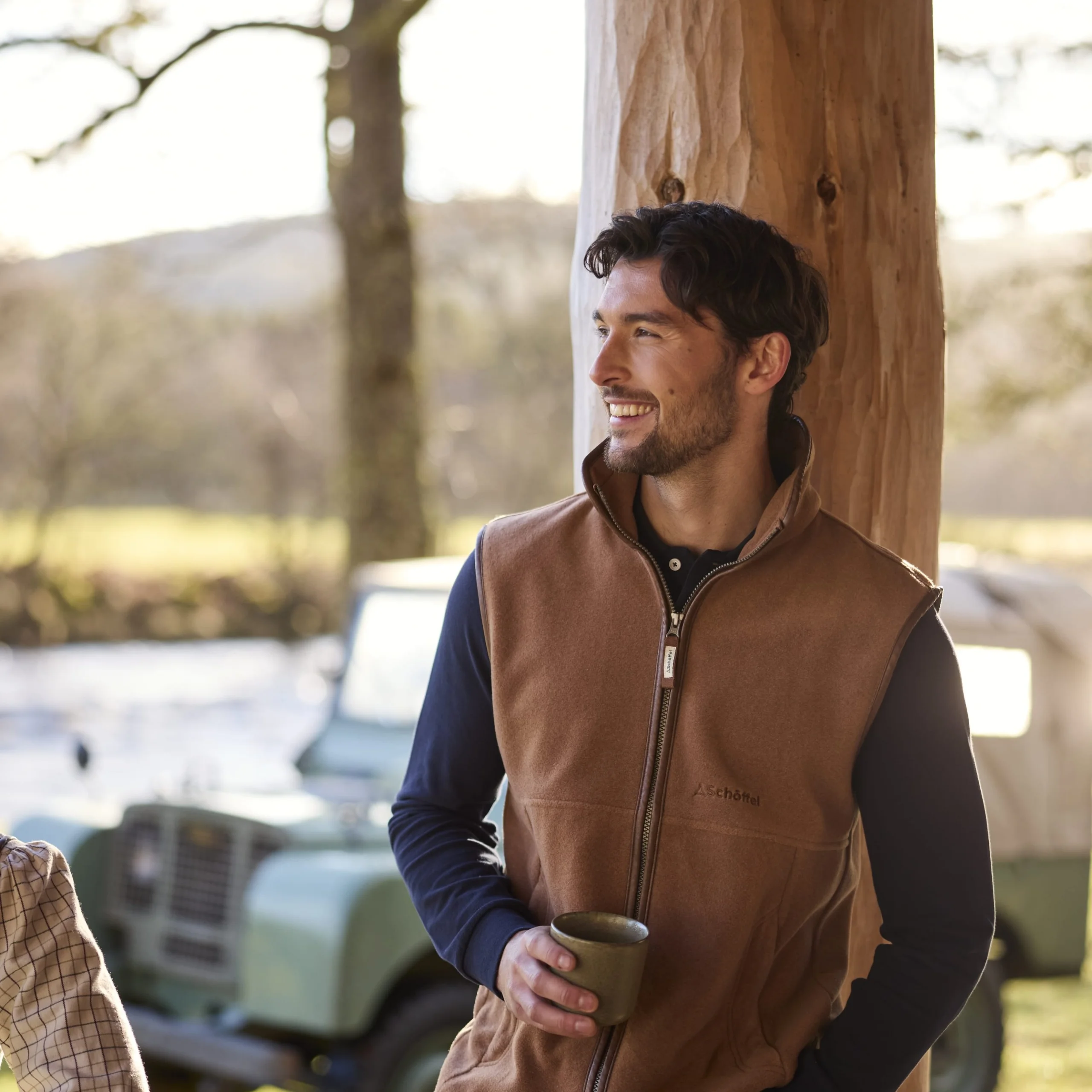 a man in a brown schoffel gilet