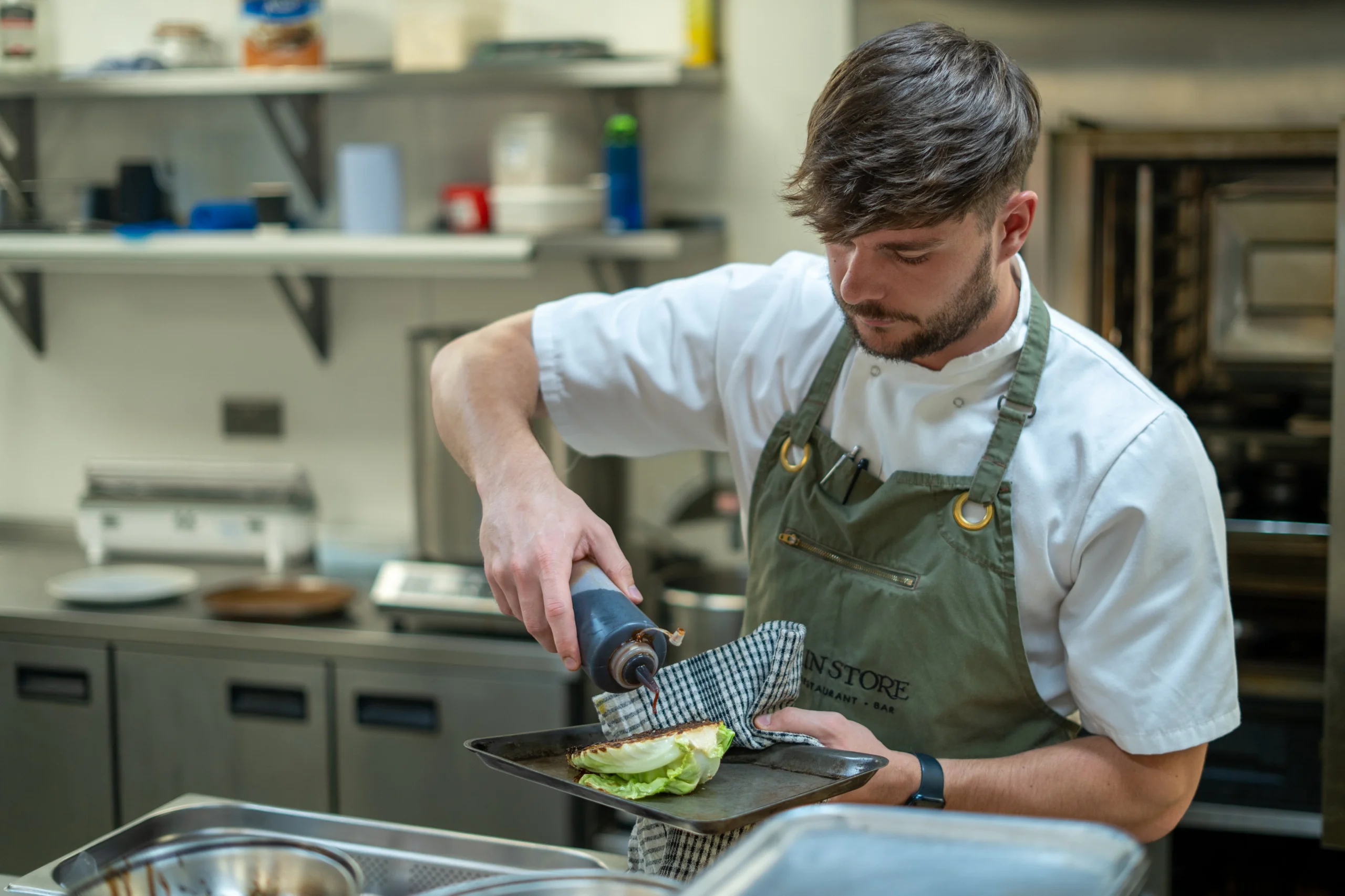a chef preparing hispi cabbage at doddington hall grain store restaurant