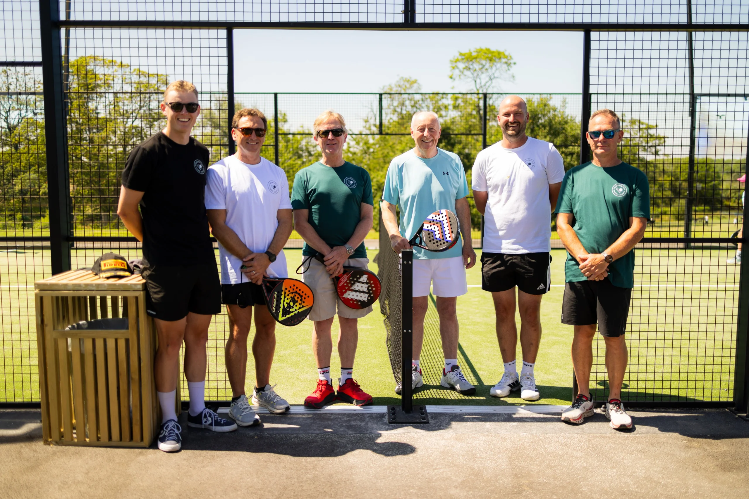 a group of male staff members playing padel at doddington hall