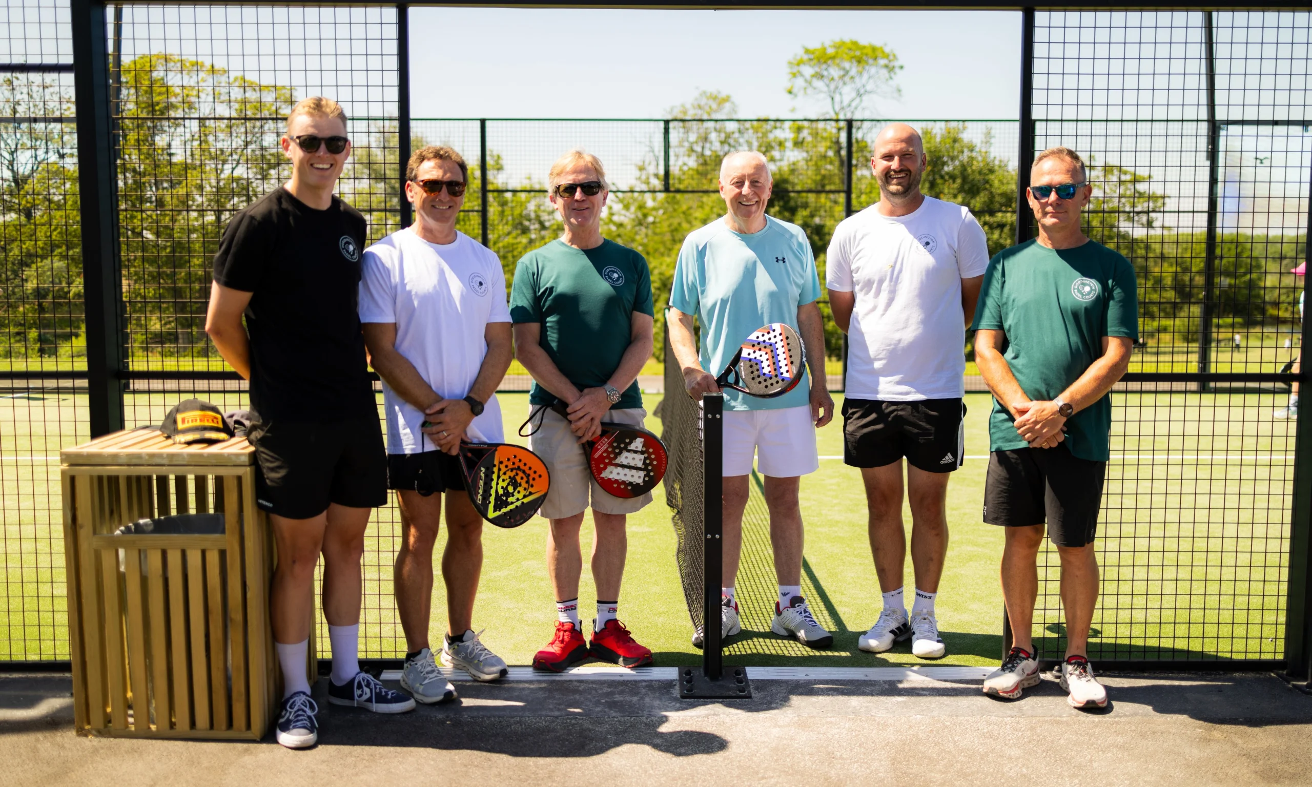 a group of male staff members playing padel at doddington hall