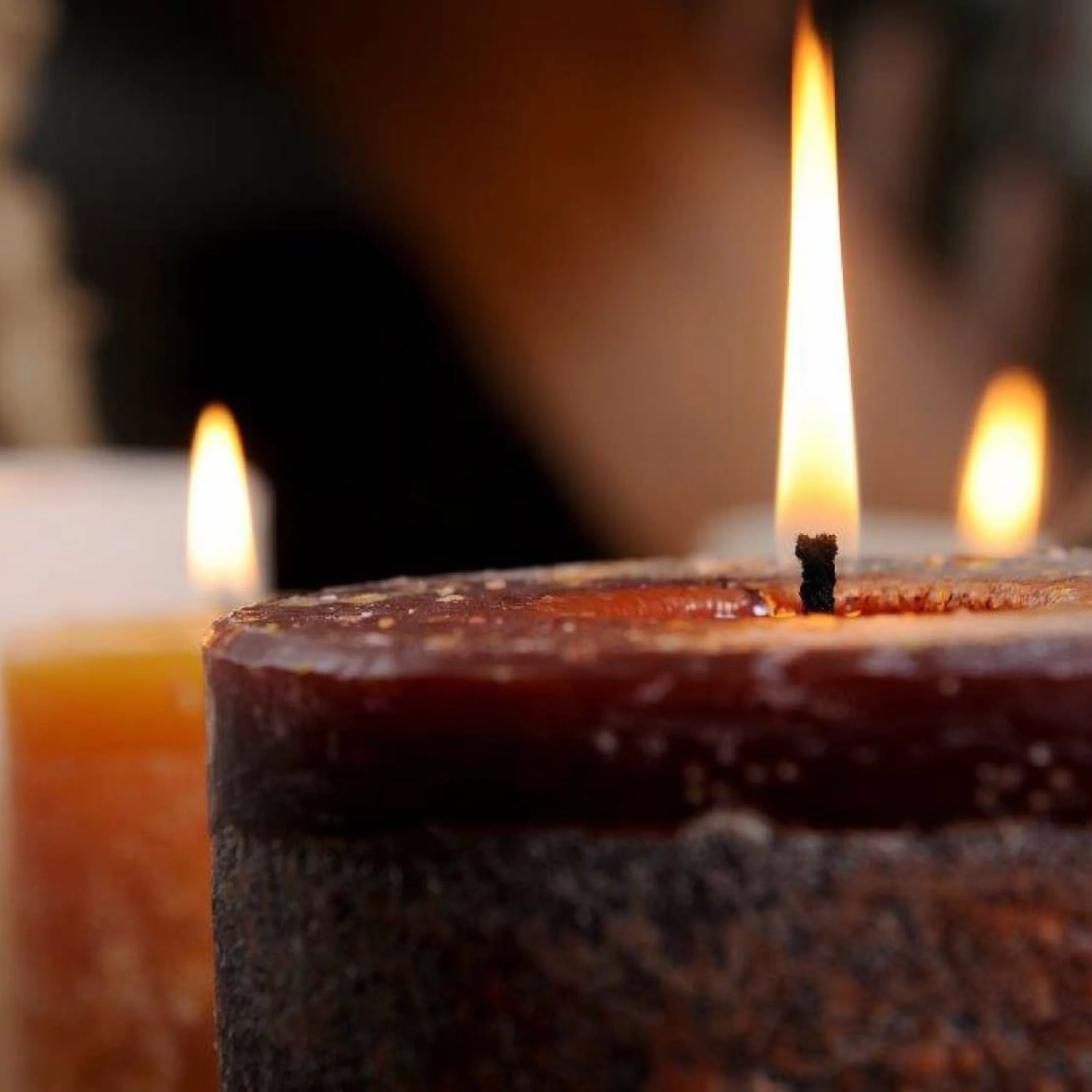 a close up of a pillar candle burning