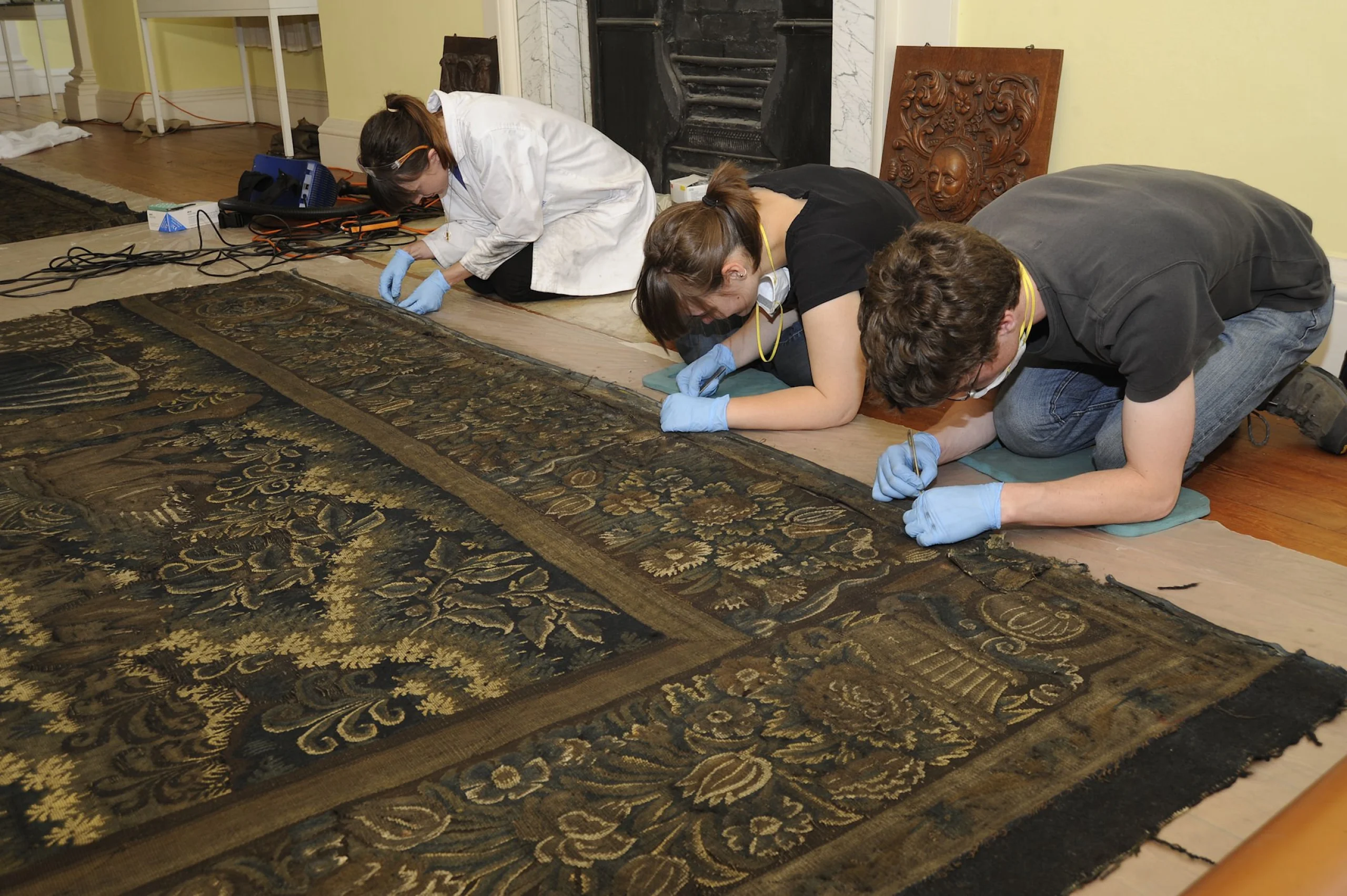 conservation artists working on tapestry