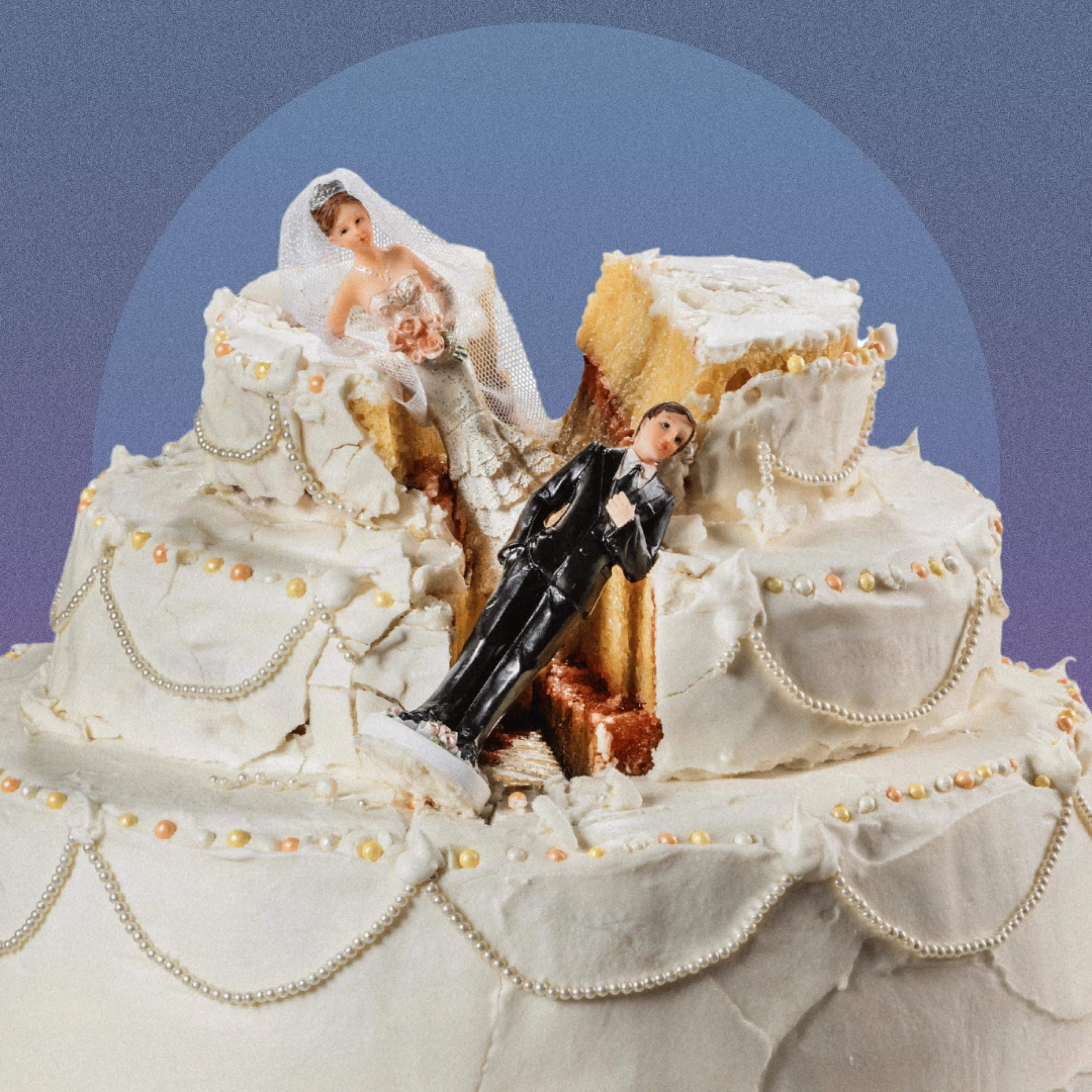 a white wedding cake with icing and pearl decorations with a bride and groom figurine