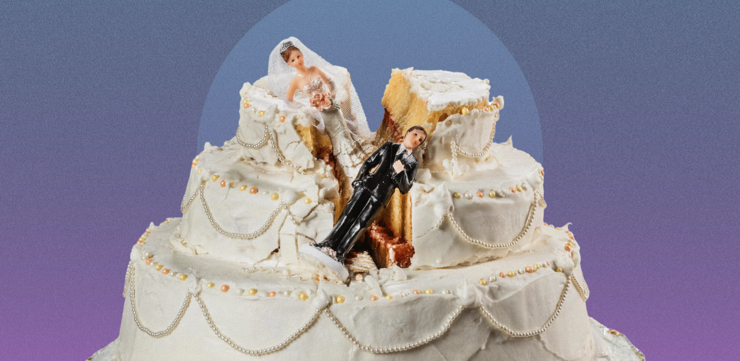 a white wedding cake with icing and pearl decorations with a bride and groom figurine