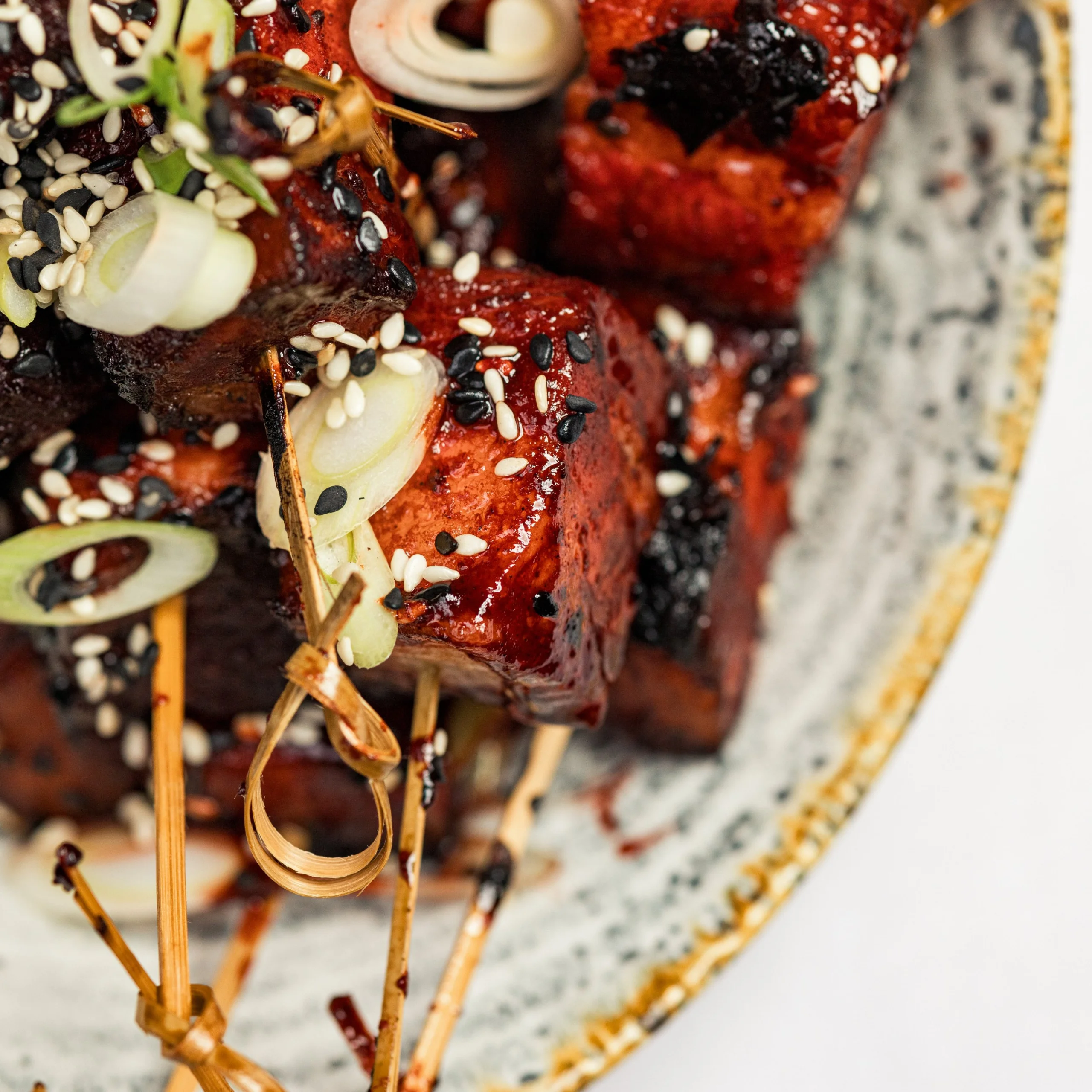 skewers of marinated tofu with spring onions