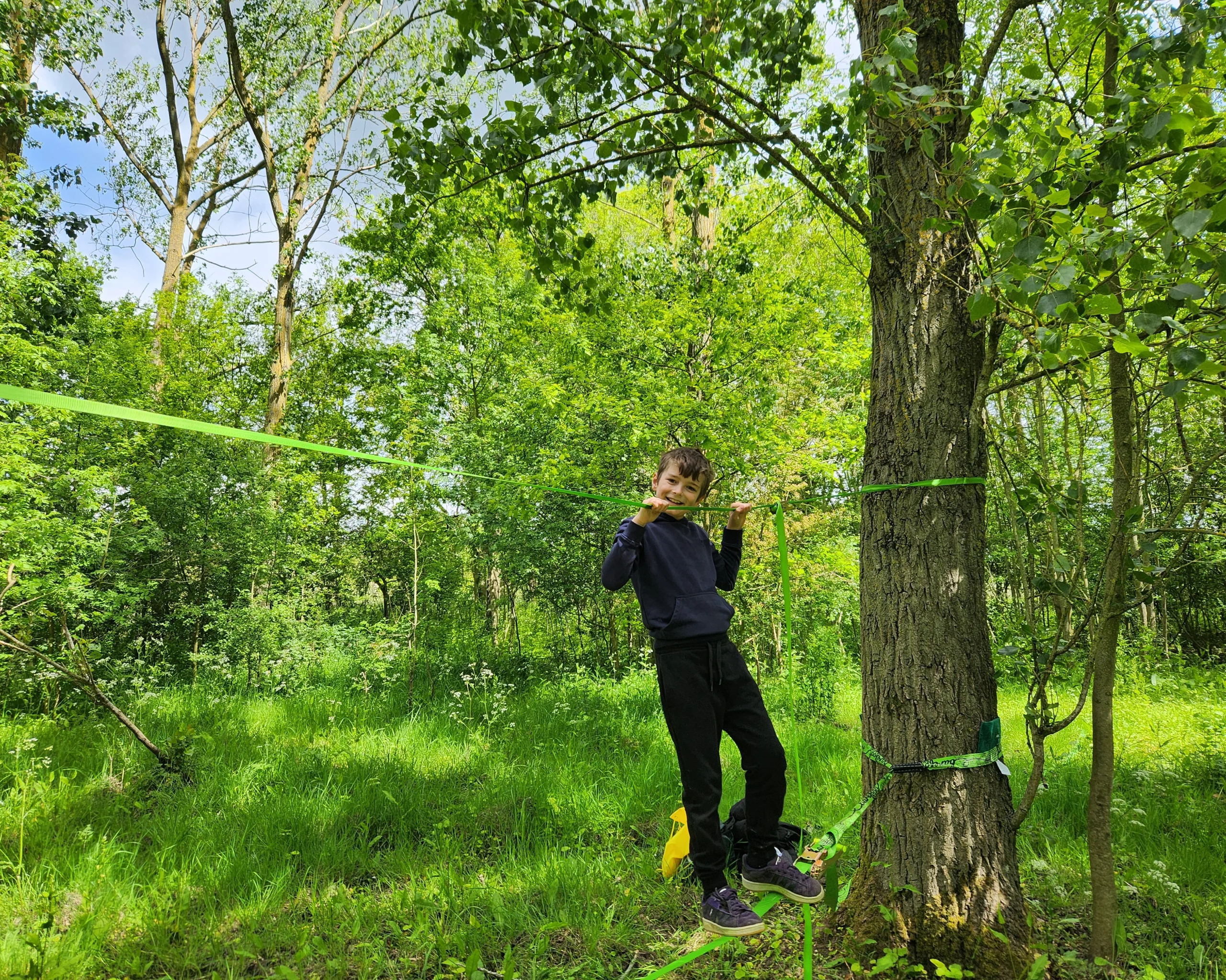 child on a balance rope between two trees at doddington hall