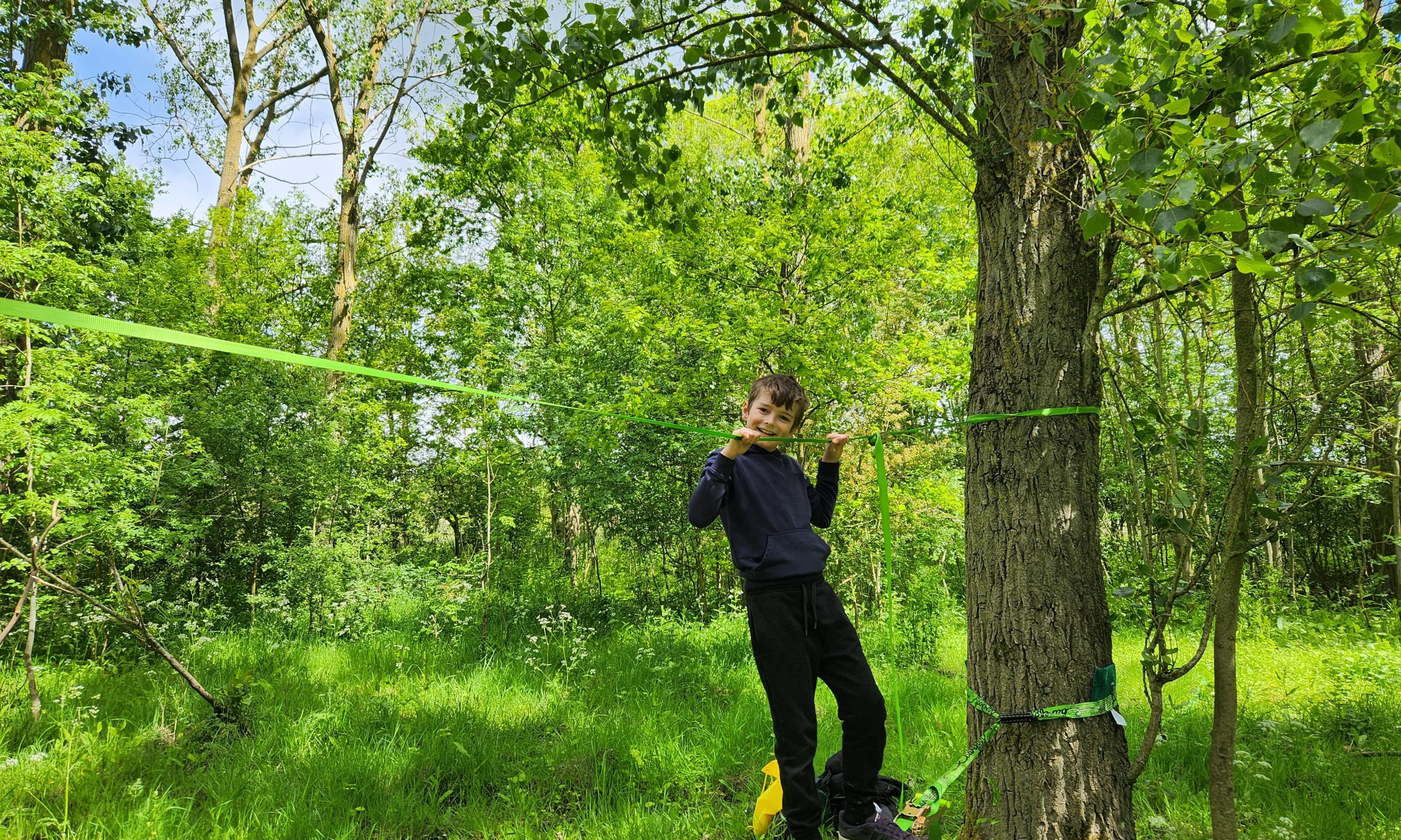 child on a balance rope between two trees at doddington hall