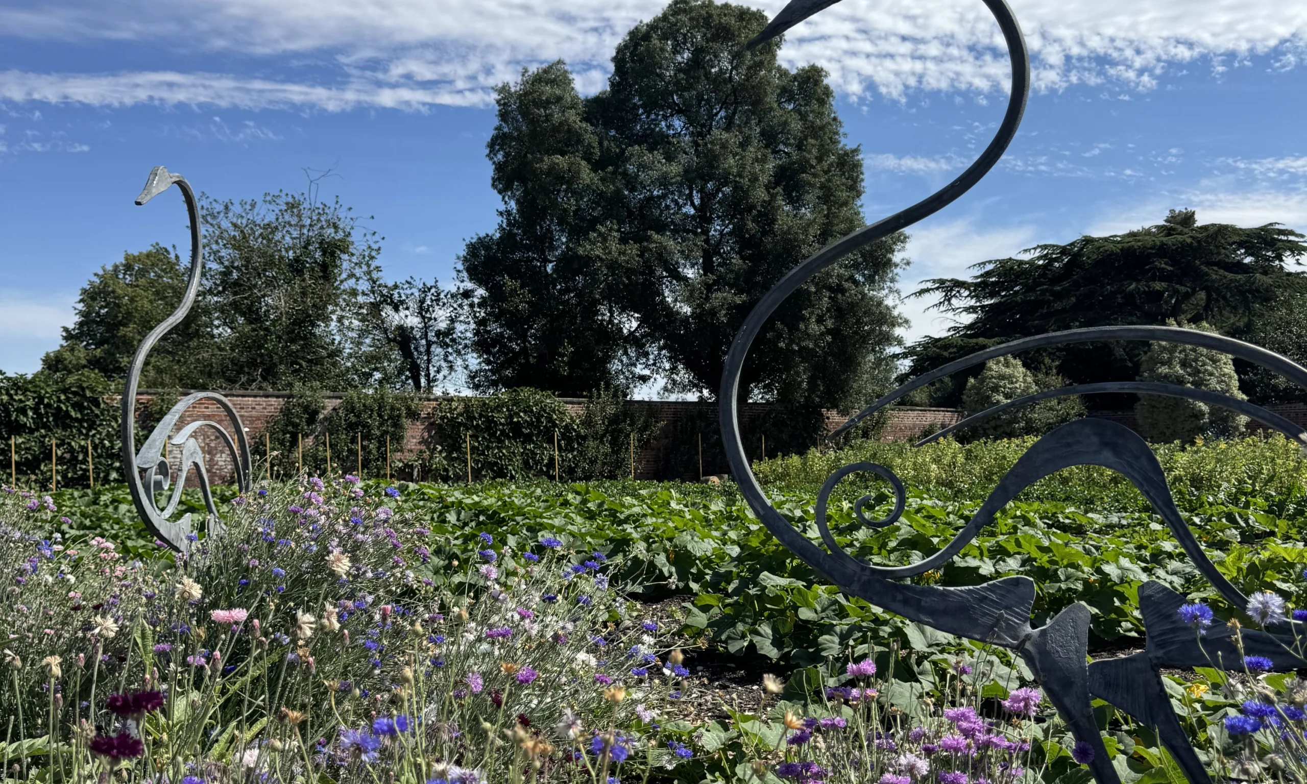 bird sculptures in a field of wildflowers