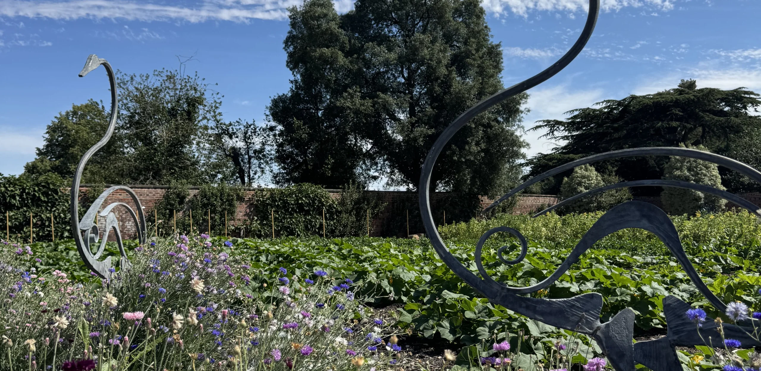 bird sculptures in a field of wildflowers
